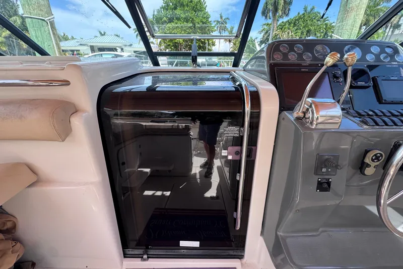 Slide: The Image of 2001 Tiara Yachts 3100 Open cockpit with helm controls and cabin entrance. - 28