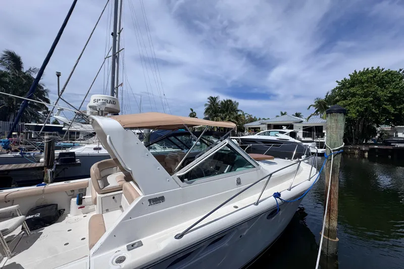 Slide: The Image of 2001 Tiara Yachts 3100 Open docked, featuring sleek design and spacious deck. - 3