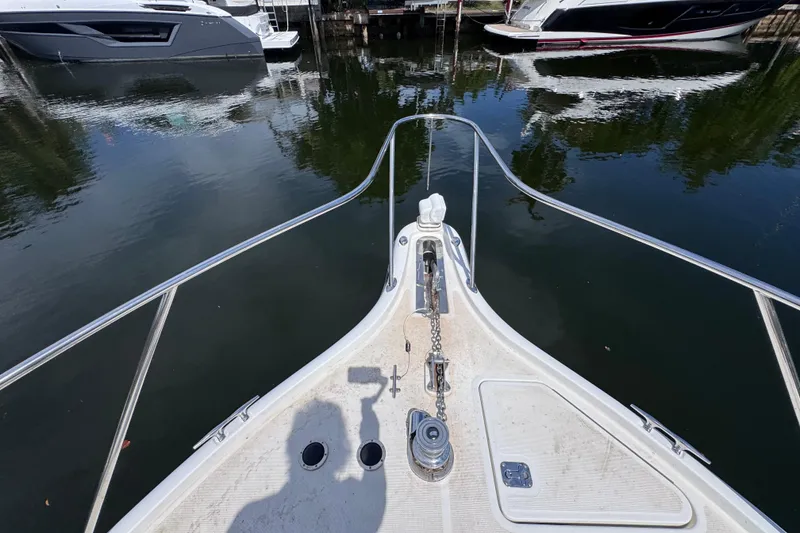 Slide: The Image of Bow view of 2001 Tiara Yachts 3100 Open, docked with surrounding boats. - 30