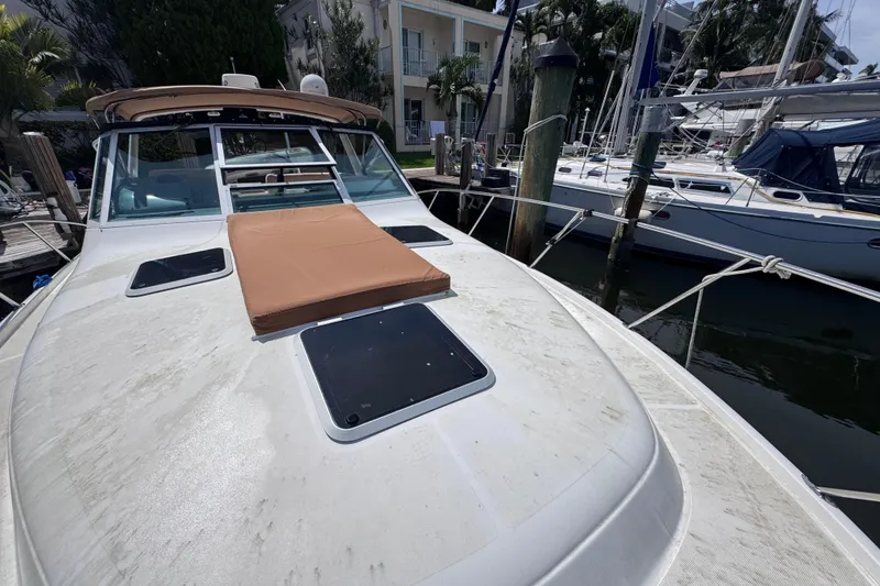 Slide: The Image of 2001 Tiara Yachts 3100 Open docked, featuring a spacious deck and sleek design. - 35