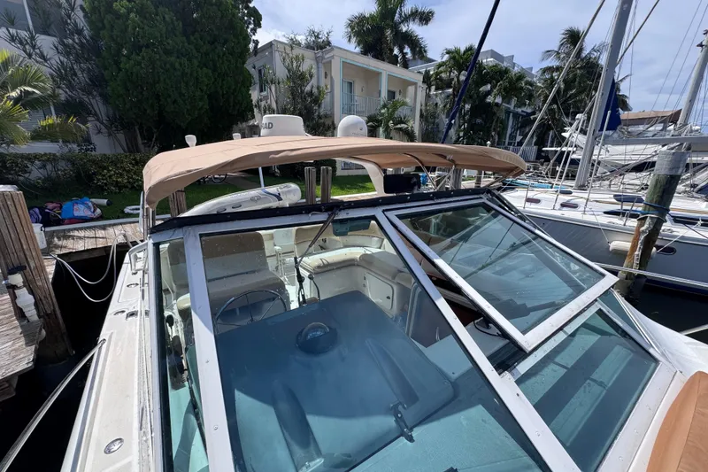 Slide: The Image of 2001 Tiara Yachts 3100 Open docked, featuring a tan canopy and spacious cockpit. - 36