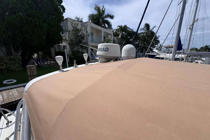 Slide: The Image of 2001 Tiara Yachts 3100 Open with beige cover docked near palm trees. - 37