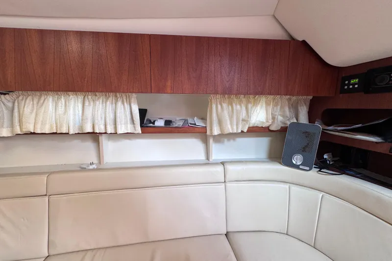 Slide: The Image of Interior of 2001 Tiara Yachts 3100 Open with wood cabinets and cream seating. - 41