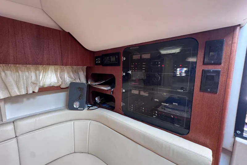 Slide: The Image of Interior of 2001 Tiara Yachts 3100 Open, featuring control panel and seating area. - 42