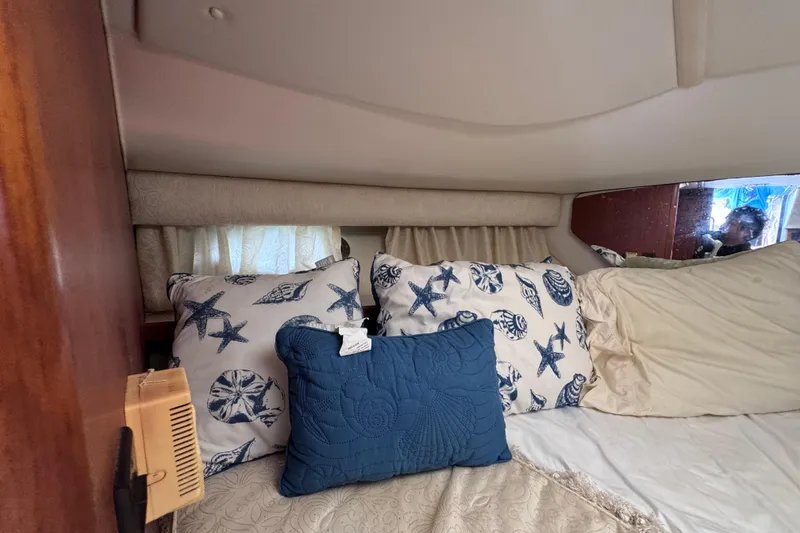 Slide: The Image of Cozy cabin interior of 2001 Tiara Yachts 3100 Open with nautical-themed pillows. - 43