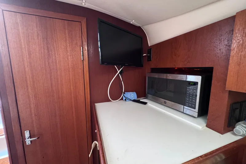 Slide: The Image of Interior of 2001 Tiara Yachts 3100 Open with TV and microwave. - 44