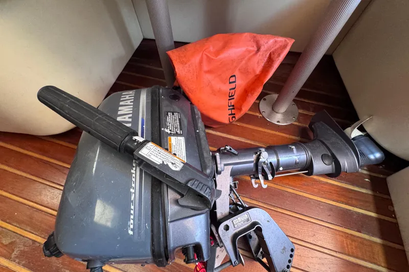 Slide: The Image of Yamaha outboard motor on Tiara Yachts 3100 Open, 2001 model, with Highfield bag on wooden deck. - 48