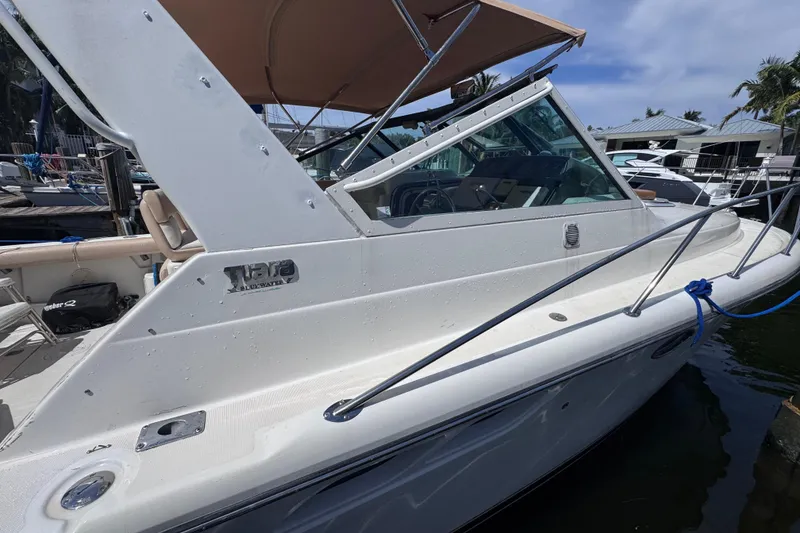 Slide: The Image of 2001 Tiara Yachts 3100 Open docked, featuring sleek design and spacious deck. - 5