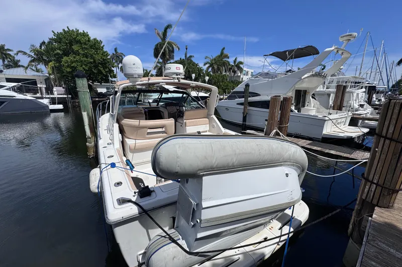 Slide: The Image of 2001 Tiara Yachts 3100 Open docked at marina, surrounded by other boats. - 7