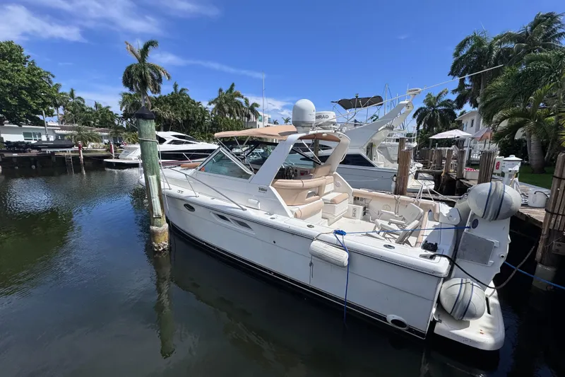 Slide: The Image of 2001 Tiara Yachts 3100 Open docked in a sunny marina with palm trees. - 9