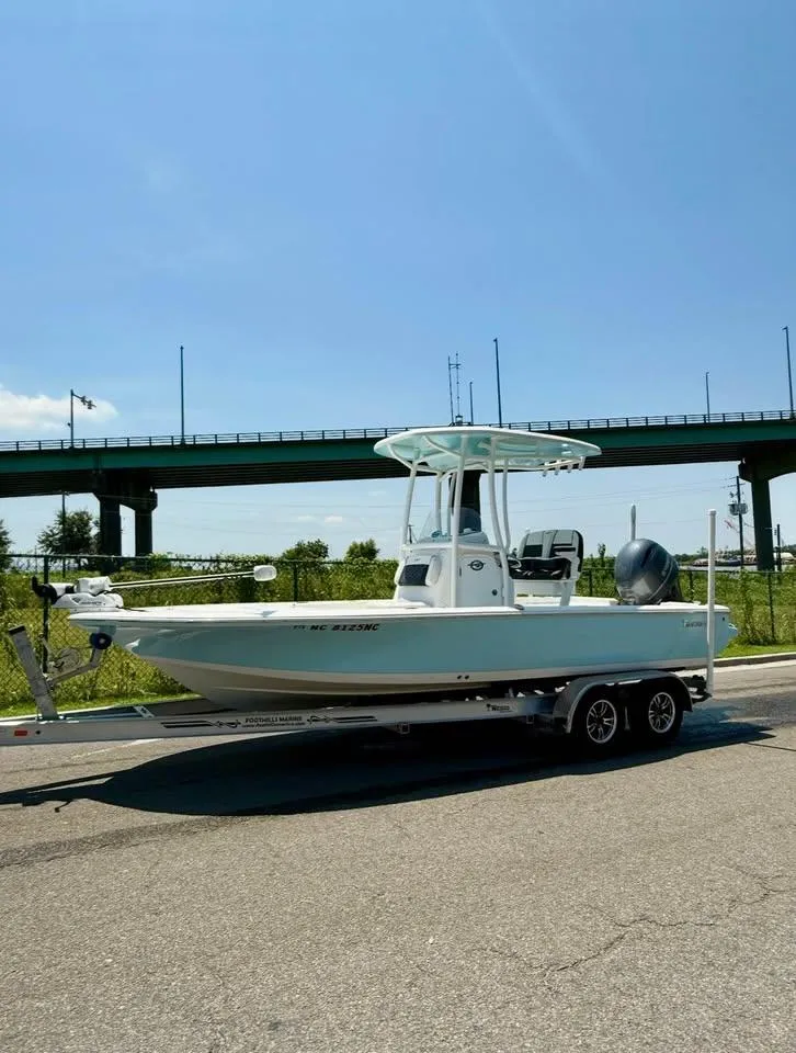 Slide: The Image of 2023 Tidewater 2110 Bay Max boat on trailer under clear blue sky. - 5