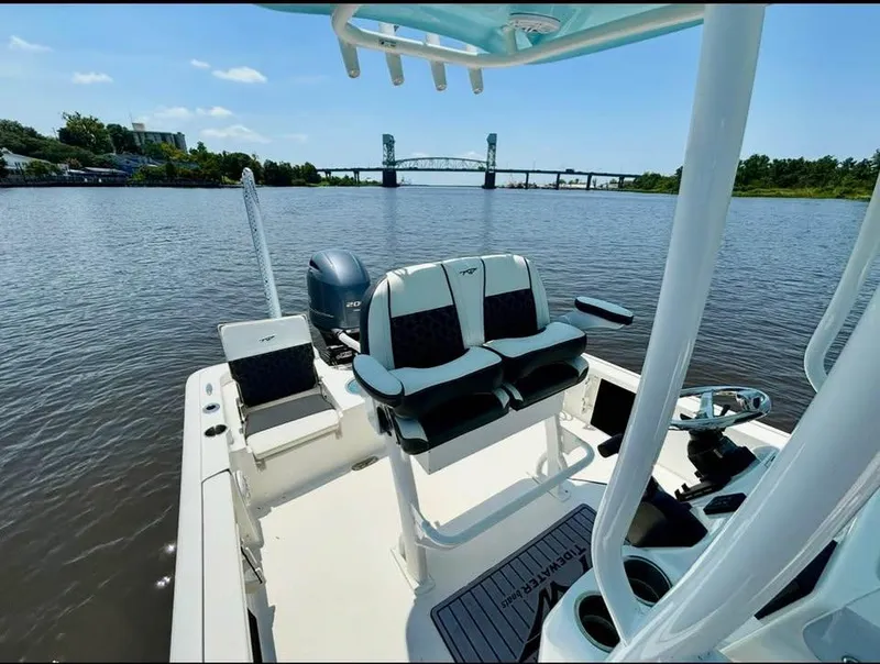 Slide: The Image of 2023 Tidewater 2110 Bay Max boat on a calm river with a bridge view. - 6
