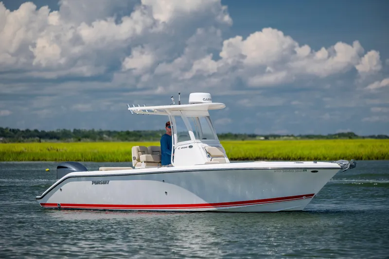 The Image of 2018 Pursuit C 238 Center Console boat on calm water under a cloudy sky. - 1