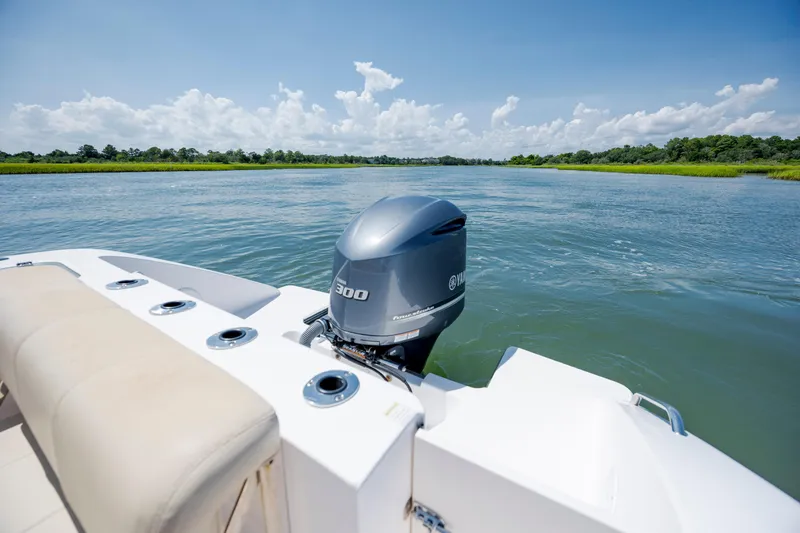Slide: The Image of 2018 Pursuit C 238 Center Console boat with Yamaha 300 engine on a serene river. - 10