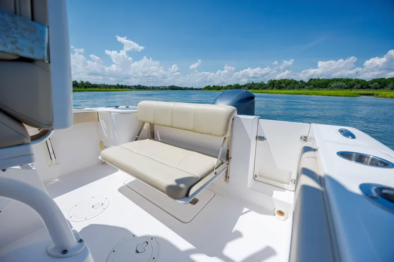 Slide: The Image of 2018 Pursuit C 238 Center Console boat interior with seating, on a sunny day. - 15
