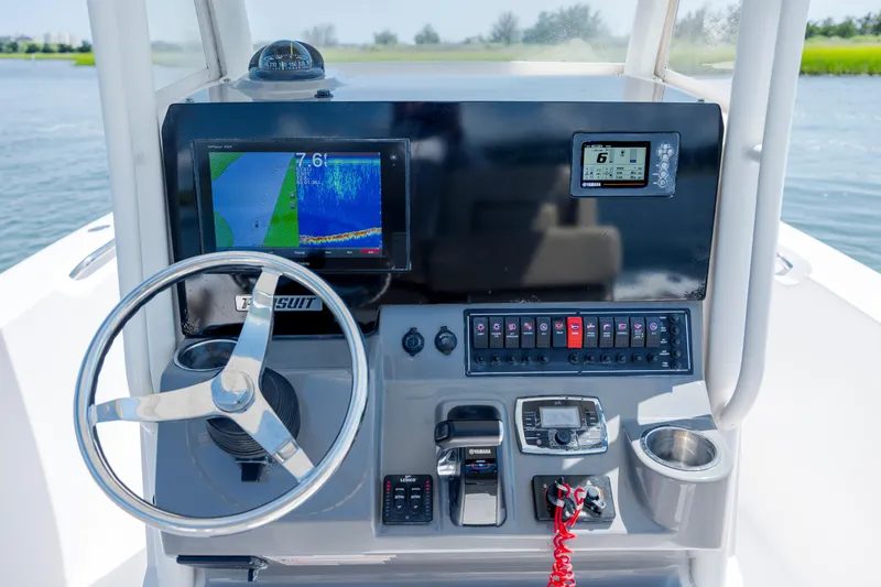 Slide: The Image of 2018 Pursuit C 238 Center Console dashboard with steering wheel and navigation displays. - 18