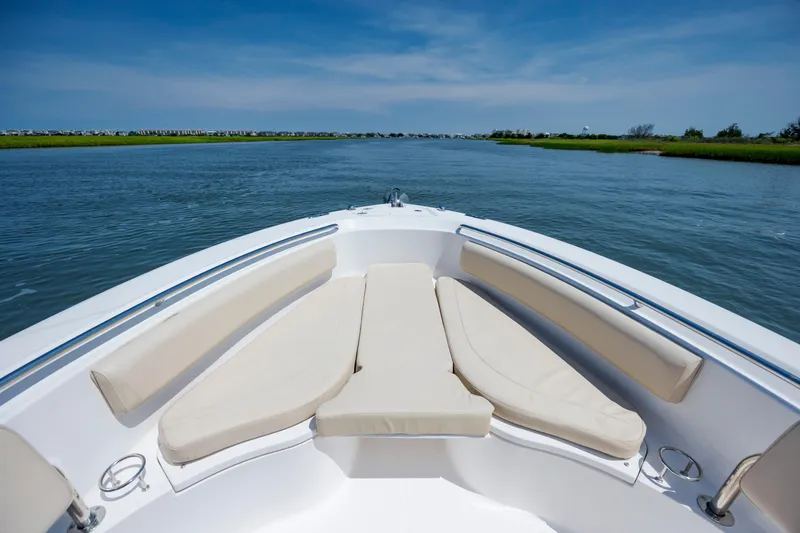 Slide: The Image of 2018 Pursuit C 238 Center Console boat on calm water, featuring comfortable seating. - 22