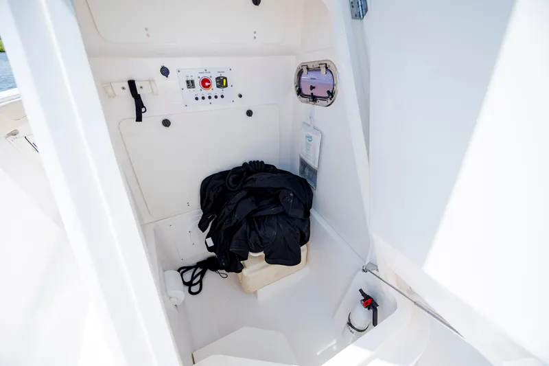 Slide: The Image of 2018 Pursuit C 238 Center Console interior with control panel and safety equipment. - 25