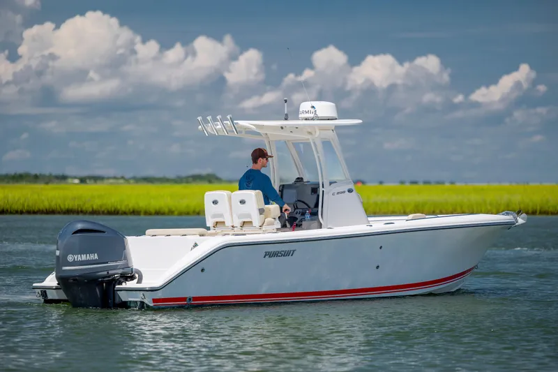 Slide: The Image of 2018 Pursuit C 238 Center Console boat on water with Yamaha engine. - 3
