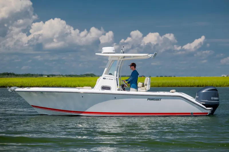 Slide: The Image of 2018 Pursuit C 238 Center Console boat on calm water, clear sky background. - 6
