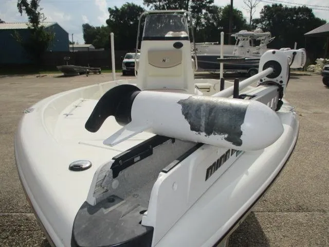 Slide: The Image of 2017 NauticStar 2140 Sport boat with trolling motor, parked outdoors. - 3
