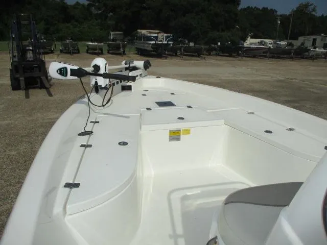 Slide: The Image of 2017 NauticStar 2140 Sport boat interior with seating and equipment, parked outdoors. - 5