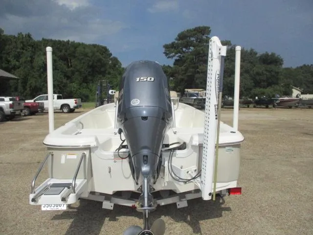 Slide: The Image of 2017 NauticStar 2140 Sport boat with 150 HP engine, parked outdoors. - 9