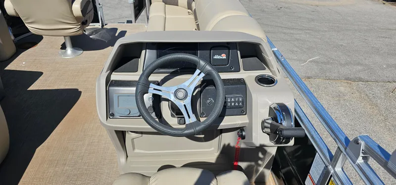 Slide: The Image of 2024 Sun Tracker SportsFish 20 DLX boat dashboard with steering wheel and controls. - 10