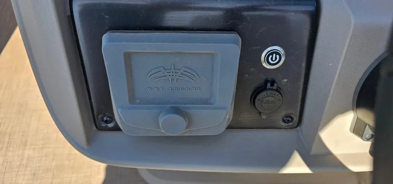 Slide: The Image of 2024 Sun Tracker SportsFish 20 DLX audio control panel with Wet Sounds branding. - 11