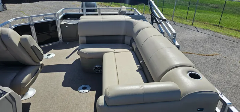 Slide: The Image of 2024 Sun Tracker SportsFish 20 DLX pontoon boat interior with beige seating and cup holders. - 14