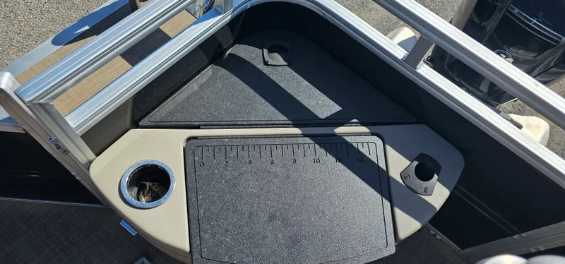 Slide: The Image of 2024 Sun Tracker SportsFish 20 DLX boat deck with cup holder and measuring board. - 15