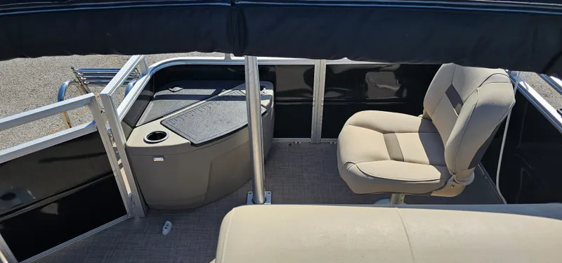 Slide: The Image of 2024 Sun Tracker SportsFish 20 DLX interior with seating and storage area. - 17