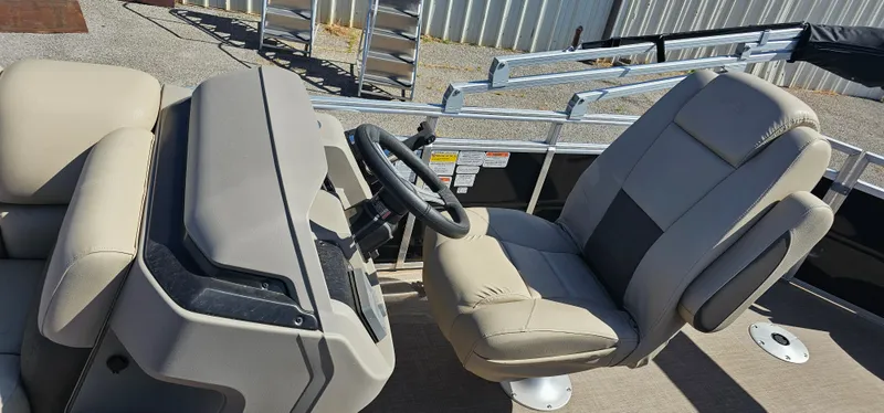 Slide: The Image of 2024 Sun Tracker SportsFish 20 DLX boat interior with steering wheel and comfortable seating. - 9