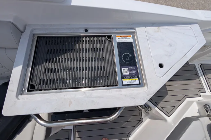 Slide: The Image of Built-in grill on 2025 Sea Ray SDX 290 boat, featuring Kenyon cooking system. - 16