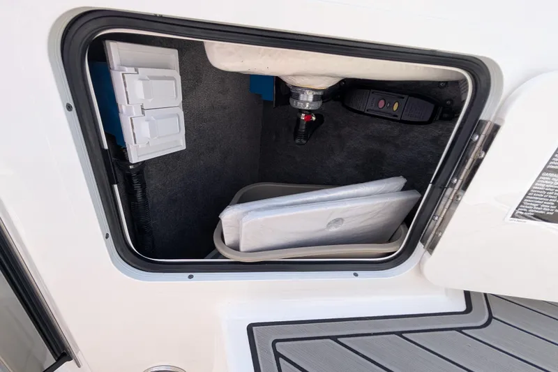 Slide: The Image of Storage compartment of 2025 Sea Ray SDX 290 boat, featuring interior equipment and accessories. - 17