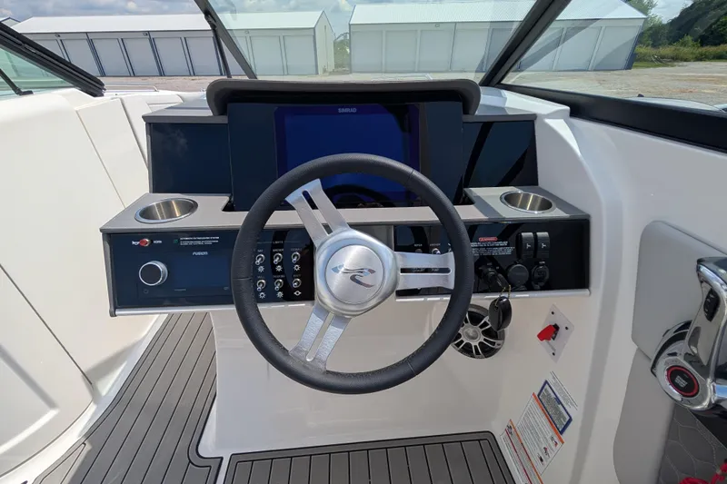 Slide: The Image of 2025 Sea Ray SDX 290 helm with modern controls and sleek steering wheel design. - 18