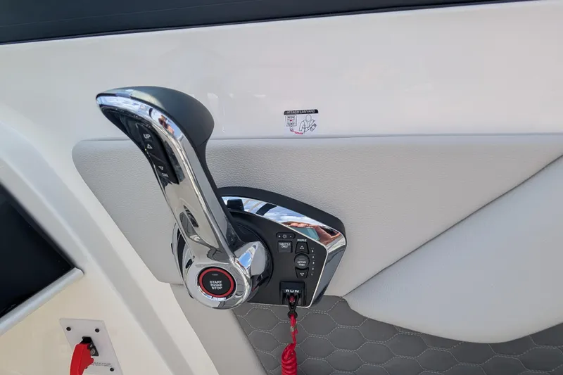 Slide: The Image of 2025 Sea Ray SDX 290 boat throttle control with start/stop button and safety lanyard. - 19
