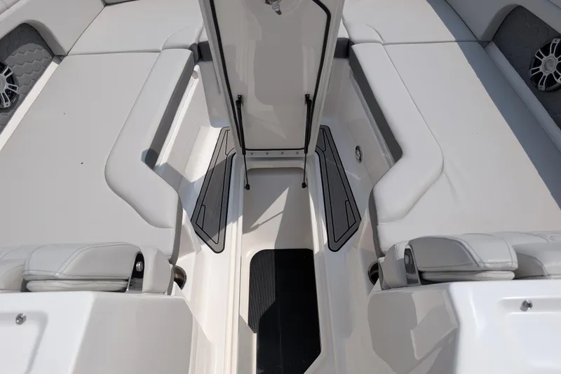 Slide: The Image of 2025 Sea Ray SDX 290 boat interior with open storage compartment and cushioned seating. - 23