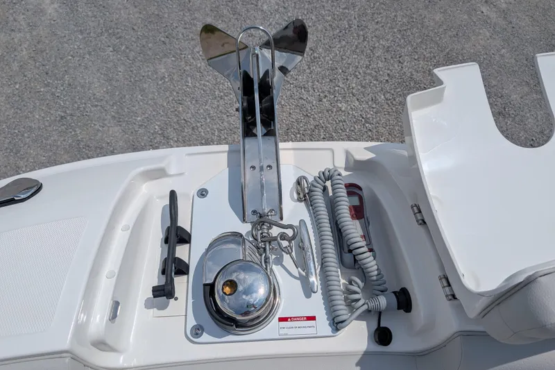 Slide: The Image of 2025 Sea Ray SDX 290 boat anchor system with coiled rope and cleat. - 24