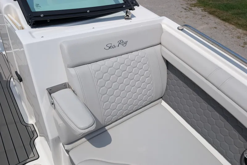 Slide: The Image of 2025 Sea Ray SDX 290 boat interior with luxurious gray seating and hexagonal pattern design. - 25