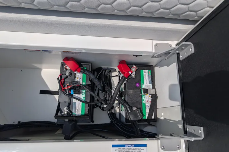 Slide: The Image of Battery compartment of 2025 Sea Ray SDX 290 boat, featuring dual marine batteries. - 26