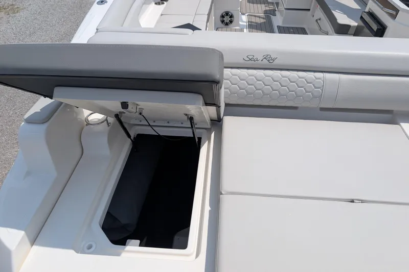 Slide: The Image of 2025 Sea Ray SDX 290 boat with open storage compartment and luxurious seating. - 28