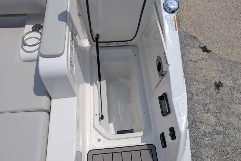 Slide: The Image of 2025 Sea Ray SDX 290 boat storage compartment with open hatch and seating area. - 30