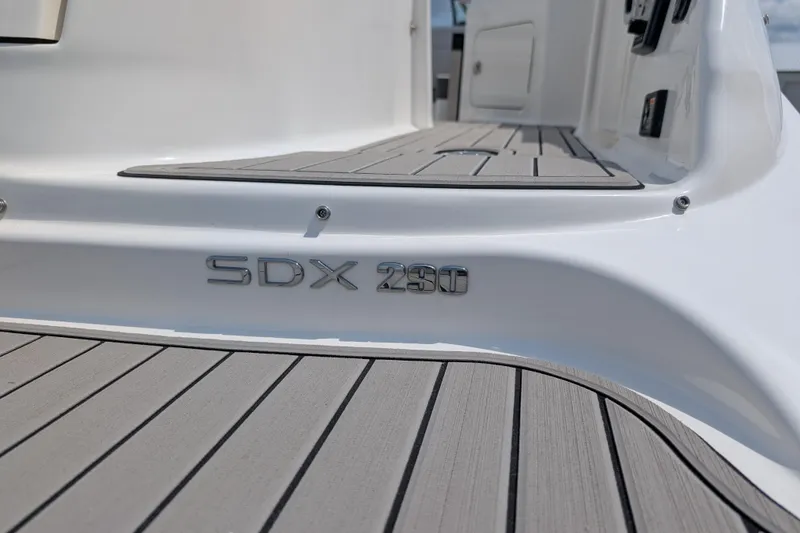 Slide: The Image of 2025 Sea Ray SDX 290 boat deck with model nameplate, featuring sleek design and modern finish. - 33