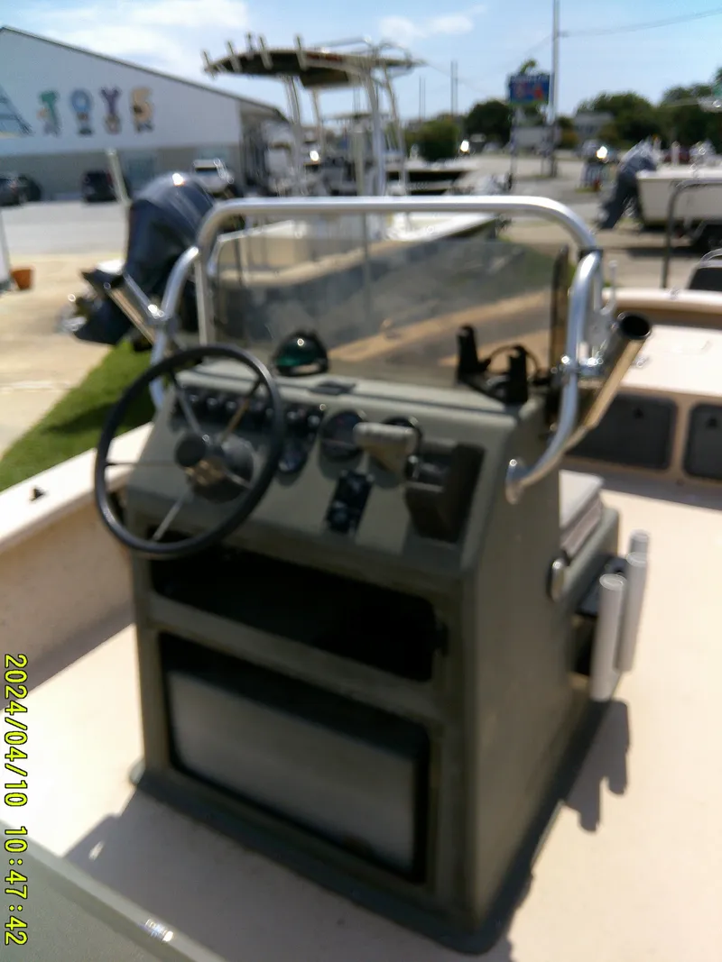 Slide: The Image of 2002 Intruder 20 Skiff boat console with steering wheel and controls. - 16