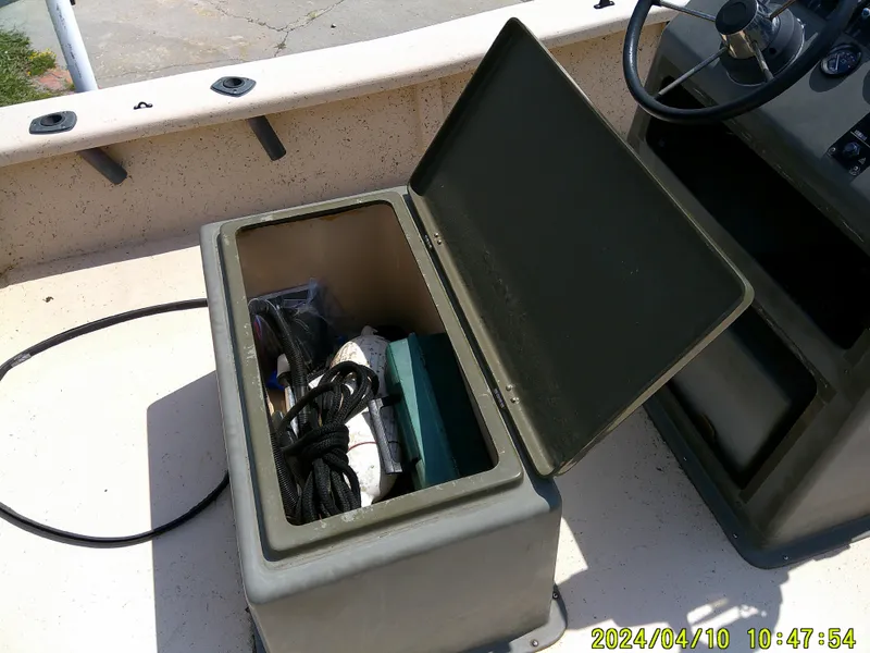 Slide: The Image of Open storage compartment on 2002 Intruder 20 Skiff boat, containing ropes and equipment. - 17