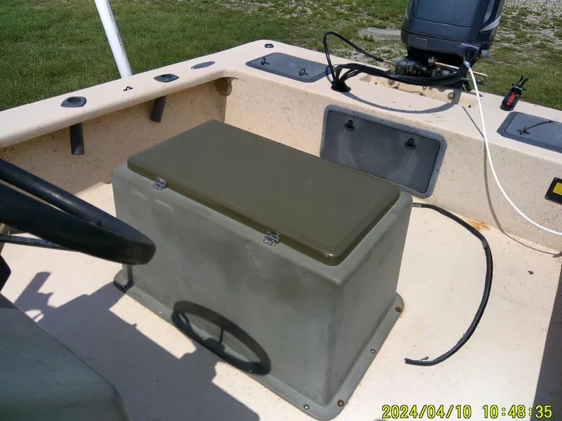 Slide: The Image of 2002 Intruder 20 Skiff boat interior with steering wheel and storage compartment. - 19