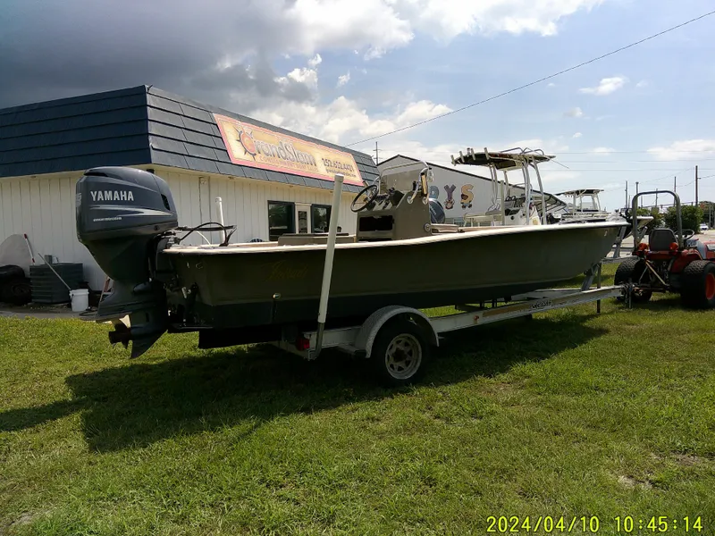 Slide: The Image of 2002 Intruder 20 Skiff boat with Yamaha motor on trailer, parked on grass. - 5