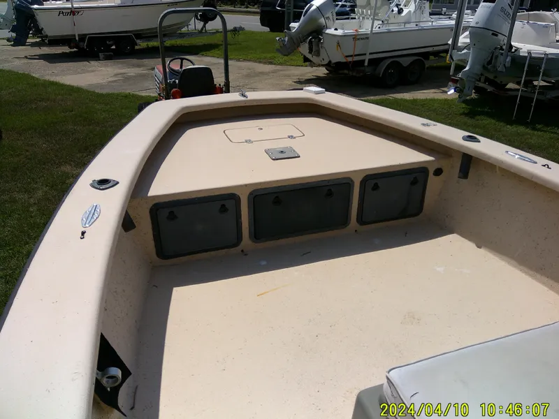 Slide: The Image of 2002 Intruder 20 Skiff boat interior with storage compartments, parked outdoors. - 8