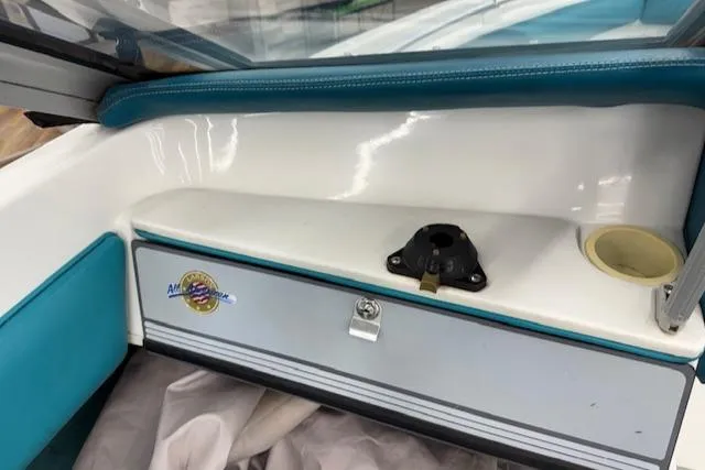 Slide: The Image of 1991 Larson All American 170 boat interior with storage compartment and teal accents. - 10
